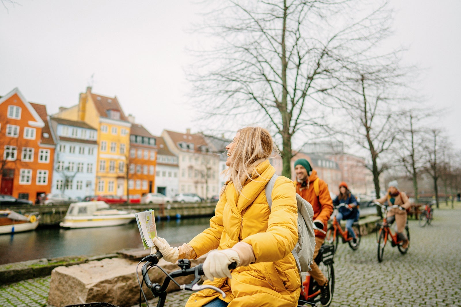 Travel guide and her group on the bicycles through the town