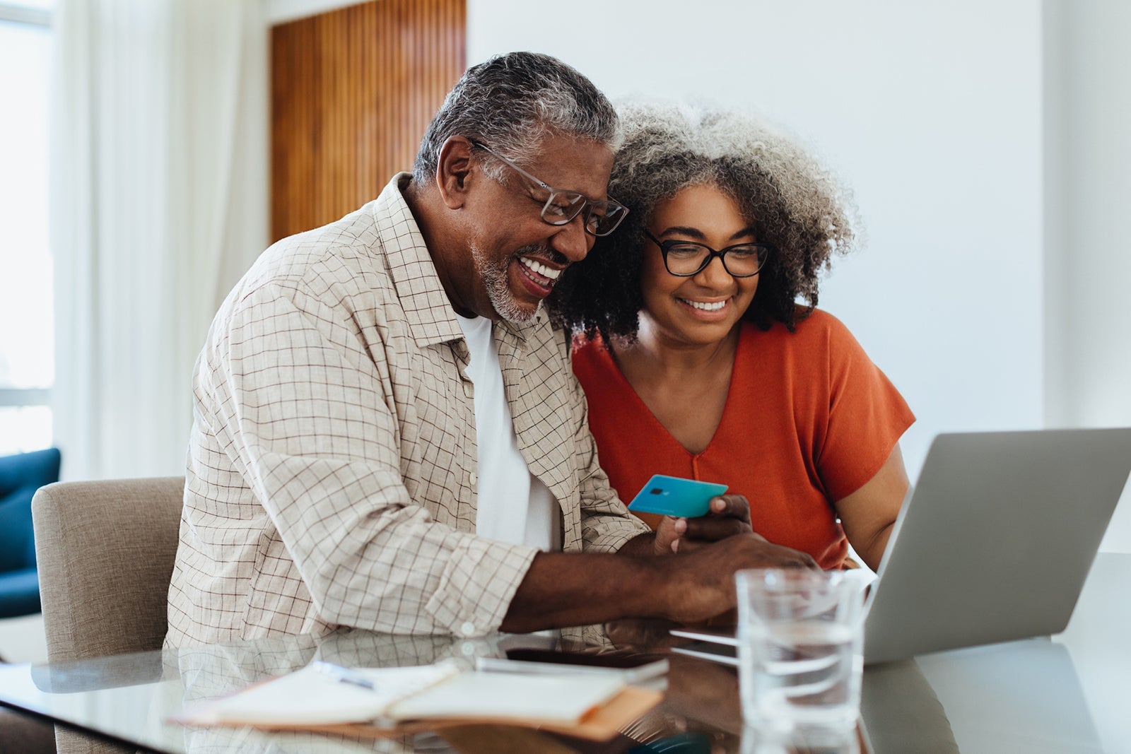 Fintech for Seniors: Confident grandparents making online payment while shopping together